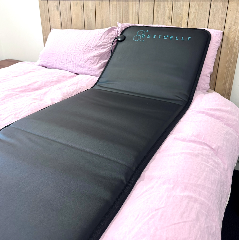 Black New Gen PEMF mat on bed
