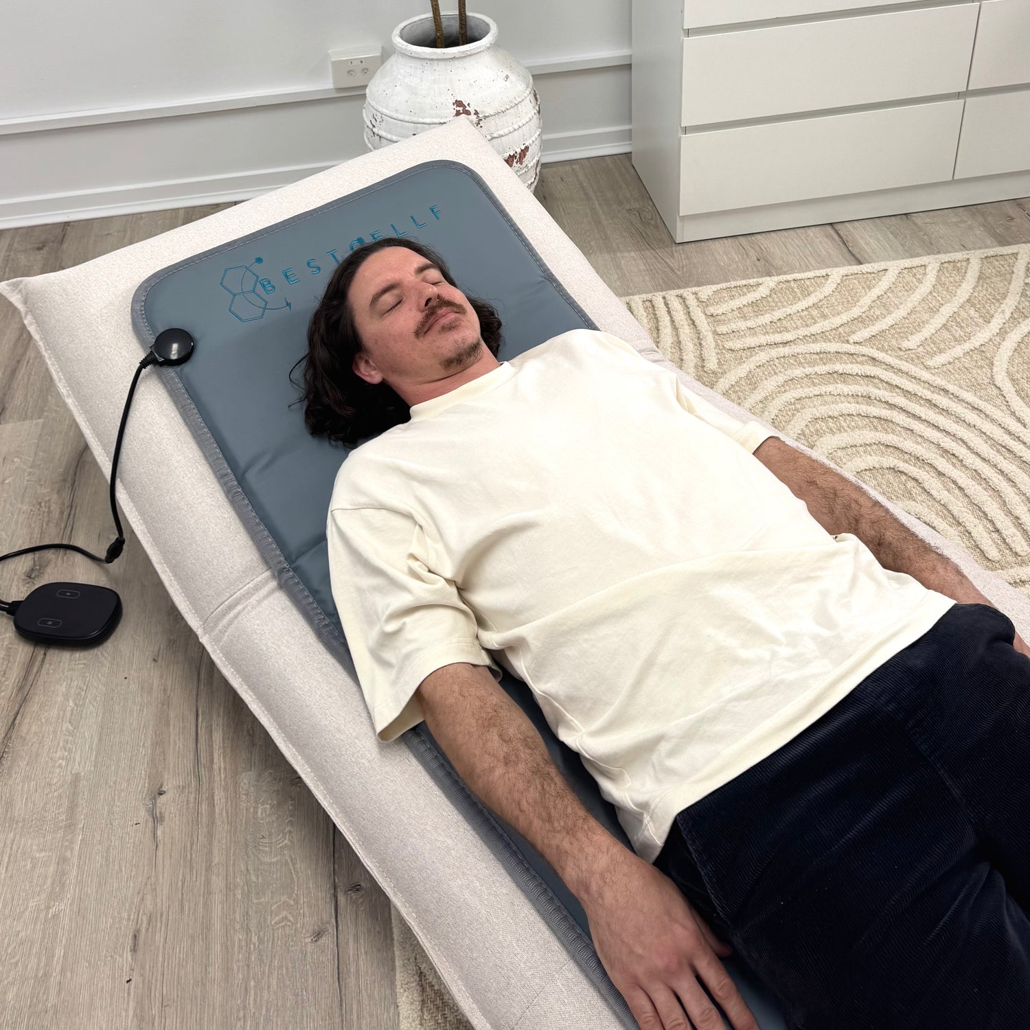 Pierre on the grey full body PEMF mat