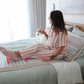 India drinking tea in bedroom on mat