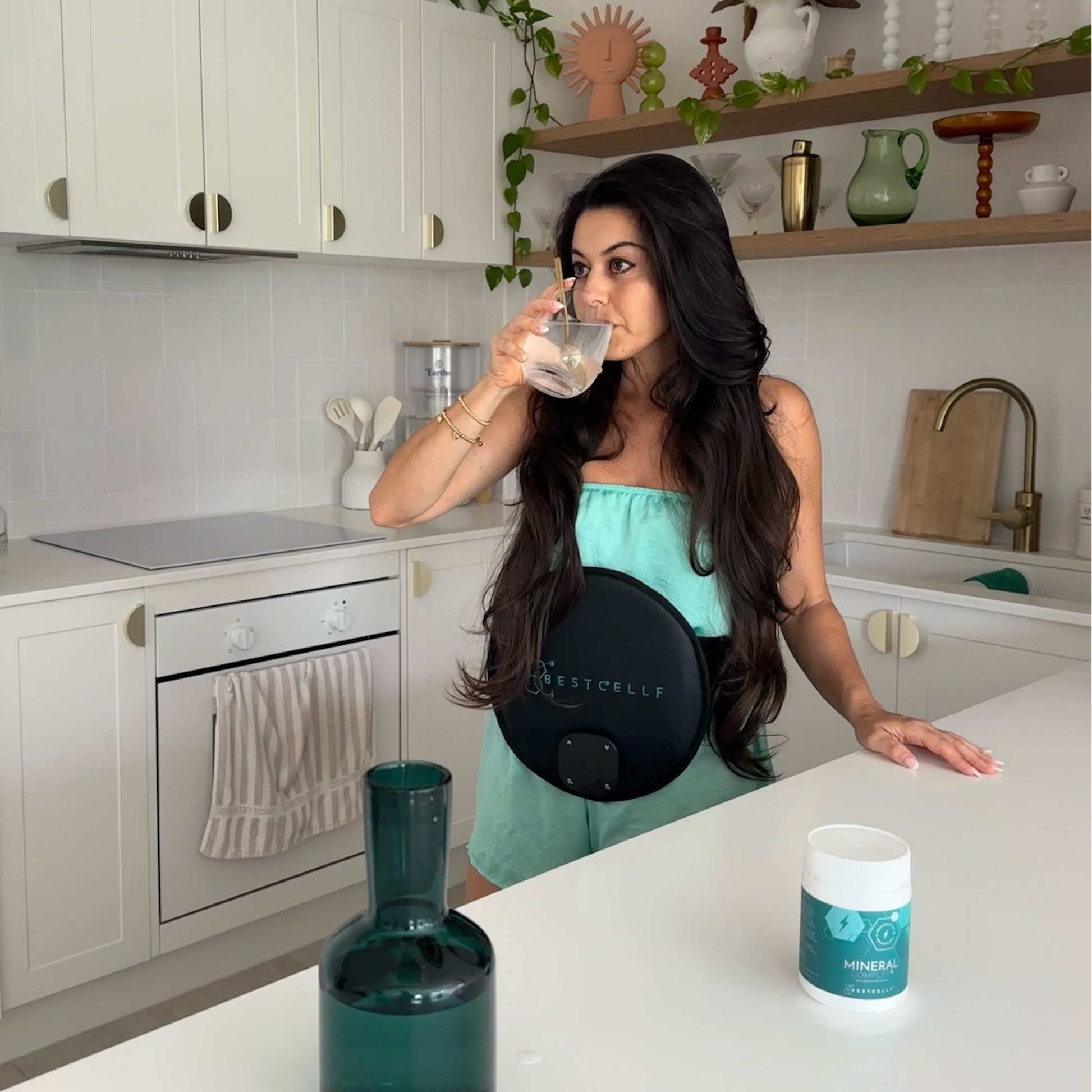 Georgia drinking Mineral Complex+ hydration powder while wearing the BEST CELLF PEMF Belt